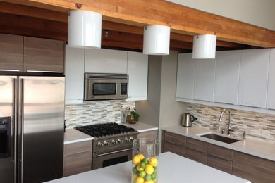 Inspiration for a contemporary l-shaped eat-in kitchen remodel in San Francisco with a single-bowl sink, flat-panel cabinets, white cabinets, quartz countertops, beige backsplash, subway tile backsplash, stainless steel appliances and an island
