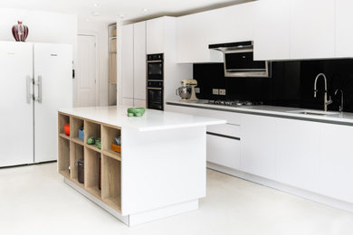 Inspiration for a medium sized contemporary single-wall kitchen/diner in London with a submerged sink, flat-panel cabinets, white cabinets, quartz worktops, an island and white worktops.
