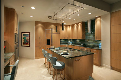 Transitional kitchen photo in Miami with light wood cabinets, stainless steel appliances and an island