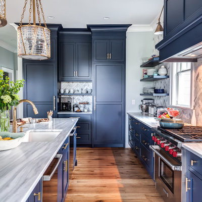 Eat-in kitchen - large transitional l-shaped medium tone wood floor and brown floor eat-in kitchen idea in New York with an undermount sink, recessed-panel cabinets, blue cabinets, granite countertops, multicolored backsplash, porcelain backsplash, stainless steel appliances, an island and gray countertops