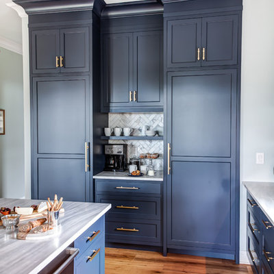 Example of a large transitional l-shaped medium tone wood floor and brown floor kitchen design in New York with an undermount sink, recessed-panel cabinets, blue cabinets, granite countertops, multicolored backsplash, porcelain backsplash, stainless steel appliances, an island and gray countertops