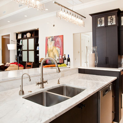 Example of a trendy kitchen design in Miami with a double-bowl sink, marble countertops, flat-panel cabinets and dark wood cabinets