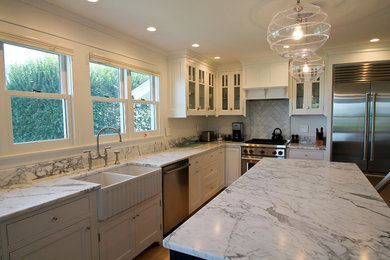 Inspiration for a mid-sized transitional l-shaped light wood floor and brown floor eat-in kitchen remodel in Bridgeport with shaker cabinets, white cabinets, multicolored backsplash, stainless steel appliances, an island, multicolored countertops and a farmhouse sink