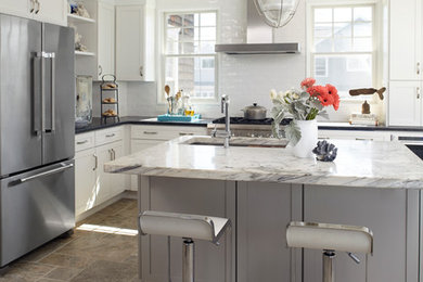 Eat-in kitchen - large coastal u-shaped limestone floor eat-in kitchen idea in New York with an undermount sink, shaker cabinets, white cabinets, granite countertops, white backsplash, subway tile backsplash, stainless steel appliances and an island