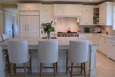 Eat-in kitchen - large coastal l-shaped ceramic tile and beige floor eat-in kitchen idea with an undermount sink, beaded inset cabinets, white cabinets, granite countertops, gray backsplash, subway tile backsplash, paneled appliances, an island and gray countertops