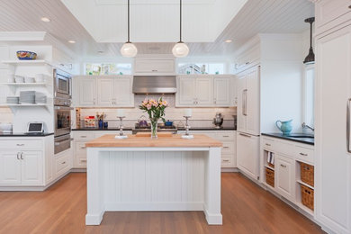 Example of a beach style u-shaped kitchen design in Seattle with an island