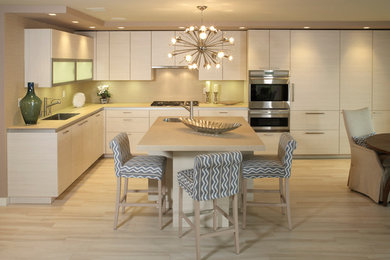 Eat-in kitchen - contemporary l-shaped eat-in kitchen idea in New York with an undermount sink, flat-panel cabinets, white cabinets and paneled appliances
