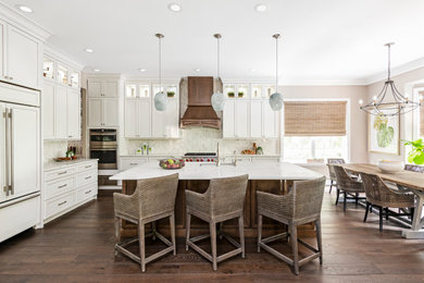Large transitional l-shaped dark wood floor and brown floor open concept kitchen photo in Tampa with an undermount sink, shaker cabinets, white cabinets, quartzite countertops, white backsplash, marble backsplash, stainless steel appliances, an island and white countertops