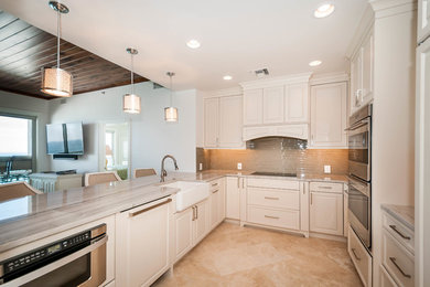Large transitional u-shaped eat-in kitchen photo in Miami with a peninsula