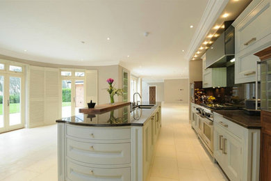 Design ideas for a contemporary enclosed kitchen in London with marble flooring.