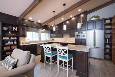 Example of a transitional cork floor kitchen design in St Louis with an undermount sink, raised-panel cabinets, dark wood cabinets, beige backsplash, stainless steel appliances and an island