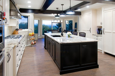Elegant eat-in kitchen photo in Calgary with an undermount sink, granite countertops and stainless steel appliances