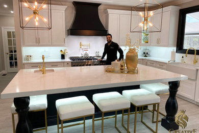 This is an example of a modern kitchen in Philadelphia with an island and white worktops.