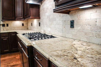 Kitchen - transitional dark wood floor kitchen idea in Los Angeles with raised-panel cabinets, dark wood cabinets, granite countertops and cement tile backsplash