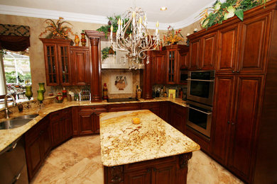 Example of a mid-sized classic u-shaped marble floor and beige floor open concept kitchen design in Orlando with a double-bowl sink, raised-panel cabinets, dark wood cabinets, granite countertops, stone tile backsplash, stainless steel appliances, an island and beige backsplash