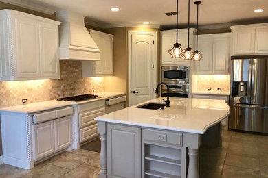 Large transitional l-shaped ceramic tile and gray floor eat-in kitchen photo in Dallas with an undermount sink, raised-panel cabinets, white cabinets, quartz countertops, multicolored backsplash, stone tile backsplash, stainless steel appliances and an island