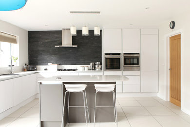 Inspiration for a contemporary kitchen in Dorset with an island and white worktops.