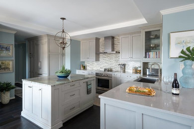 Large beach style u-shaped dark wood floor and brown floor eat-in kitchen photo in Dallas with an undermount sink, recessed-panel cabinets, white cabinets, quartz countertops, multicolored backsplash, matchstick tile backsplash, stainless steel appliances, an island and white countertops