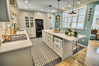 Example of a classic galley eat-in kitchen design in Burlington with quartz countertops and an island