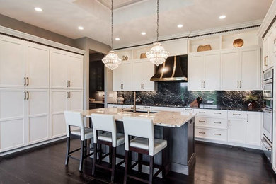 Inspiration for a mid-sized transitional u-shaped dark wood floor and brown floor eat-in kitchen remodel in Louisville with shaker cabinets, white cabinets, an undermount sink, granite countertops, black backsplash, stone slab backsplash, stainless steel appliances, an island and black countertops