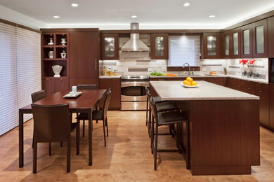Trendy l-shaped eat-in kitchen photo in Minneapolis with an undermount sink, flat-panel cabinets, dark wood cabinets, quartz countertops, gray backsplash, ceramic backsplash and stainless steel appliances
