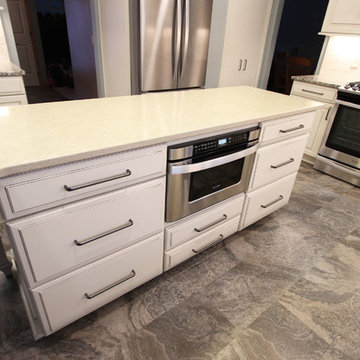 Beige Kitchen with Extra Large Island, Tile Backsplash and Granite Countertops