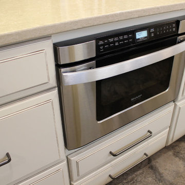 Beige Kitchen with Extra Large Island, Tile Backsplash and Granite Countertops