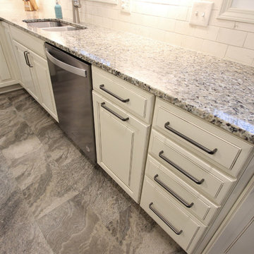 Beige Kitchen with Extra Large Island, Tile Backsplash and Granite Countertops