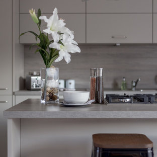 Design ideas for a mid-sized midcentury galley eat-in kitchen in Other with flat-panel cabinets, grey cabinets, limestone benchtops, grey splashback, marble splashback, laminate floors, with island, grey floor and grey benchtop.