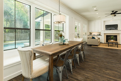 Example of a transitional laminate floor and brown floor kitchen/dining room combo design in Houston