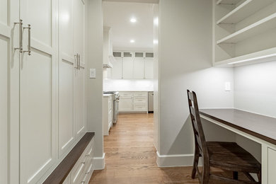 Mid-sized transitional u-shaped medium tone wood floor and brown floor kitchen pantry photo in Houston with shaker cabinets, white cabinets, quartzite countertops, white backsplash, porcelain backsplash, stainless steel appliances, a peninsula and gray countertops