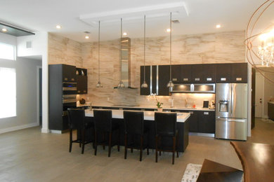 Inspiration for a large modern l-shaped open concept kitchen remodel in Tampa with an undermount sink, flat-panel cabinets, dark wood cabinets, quartzite countertops, brown backsplash, stone slab backsplash, stainless steel appliances and an island