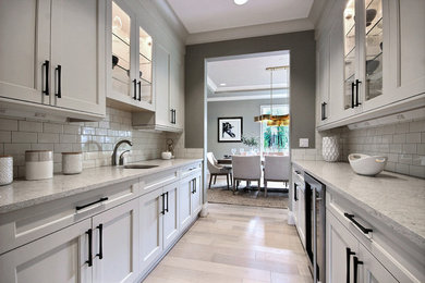 Example of a transitional kitchen design in Seattle with an undermount sink, flat-panel cabinets, white cabinets and stainless steel appliances