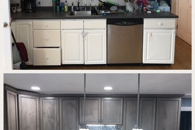 Inspiration for a mid-sized modern l-shaped medium tone wood floor and orange floor kitchen pantry remodel in Boston with an undermount sink, recessed-panel cabinets, gray cabinets, quartz countertops, gray backsplash, marble backsplash, stainless steel appliances, an island and white countertops