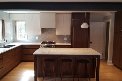 Example of a trendy light wood floor kitchen design in Ottawa with a double-bowl sink, flat-panel cabinets, dark wood cabinets, quartz countertops, blue backsplash, ceramic backsplash, stainless steel appliances, an island and white countertops