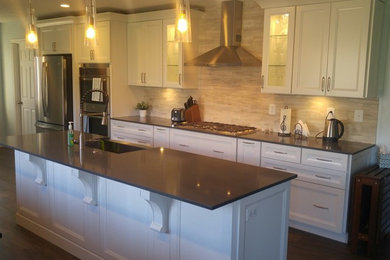 Medium sized classic galley kitchen/diner in Salt Lake City with a belfast sink, recessed-panel cabinets, white cabinets, engineered stone countertops, beige splashback, limestone splashback, stainless steel appliances, vinyl flooring, an island and grey floors.
