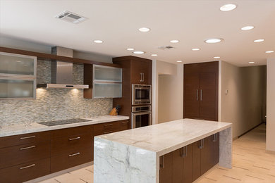 Example of a large trendy galley open concept kitchen design in Phoenix with a drop-in sink, flat-panel cabinets, medium tone wood cabinets, granite countertops, blue backsplash, mosaic tile backsplash, stainless steel appliances and an island