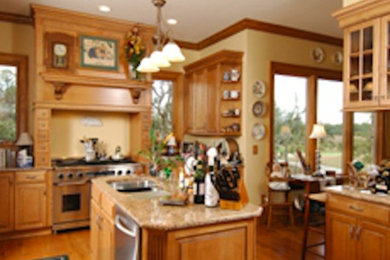 Example of a large kitchen design in Charleston with a drop-in sink, white cabinets and an island