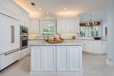 Kitchen - large transitional kitchen idea in Other with shaker cabinets, white cabinets, white backsplash, an island and quartzite countertops