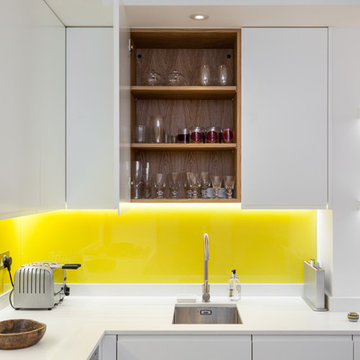 Bespoke cabinets and yellow glass splashbacks.