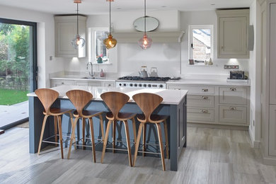 Inspiration for a medium sized traditional single-wall kitchen/diner in Other with quartz worktops, an island, a submerged sink, shaker cabinets, grey cabinets, stainless steel appliances, grey floors, white worktops, white splashback and porcelain flooring.