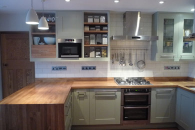 Medium sized contemporary kitchen in West Midlands with wood worktops and white splashback.