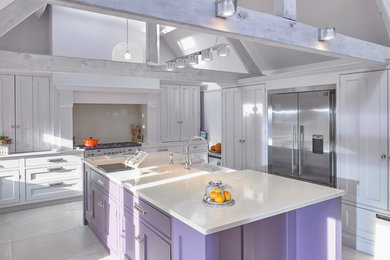 Inspiration for a large classic single-wall kitchen/diner in Cheshire with a belfast sink, recessed-panel cabinets, purple cabinets, quartz worktops, beige splashback, stainless steel appliances, porcelain flooring, an island, beige floors and beige worktops.