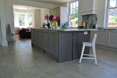 Photo of a single-wall open plan kitchen in Dorset with grey cabinets and an island.