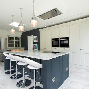 Inspiration for a medium sized classic l-shaped kitchen in Other with a submerged sink, an island, white floors, shaker cabinets, blue cabinets and stainless steel appliances.