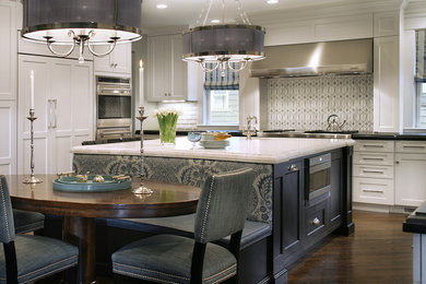 Transitional u-shaped eat-in kitchen photo in New York with a farmhouse sink, recessed-panel cabinets, granite countertops, gray backsplash, glass tile backsplash, stainless steel appliances and white cabinets