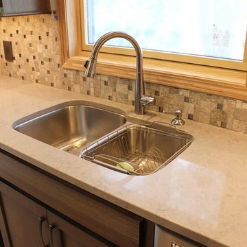 Bettendorf, IA- Gorgeous Galley Kitchen Remodel With Gray Stain and Quartz Tops