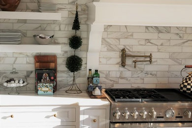 Kitchen - mid-sized transitional u-shaped dark wood floor and brown floor kitchen idea in Detroit with marble backsplash, white countertops, a farmhouse sink, shaker cabinets, white cabinets, white backsplash, paneled appliances and an island