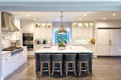 Example of a large classic l-shaped light wood floor and brown floor eat-in kitchen design in Los Angeles with an undermount sink, raised-panel cabinets, white cabinets, stainless steel appliances, an island, granite countertops, gray backsplash, stone slab backsplash and gray countertops