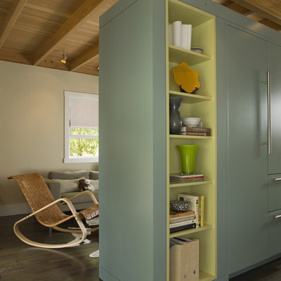 Example of a mid-sized eclectic l-shaped dark wood floor open concept kitchen design in San Francisco with green cabinets, paneled appliances, an island, an undermount sink, open cabinets and black backsplash